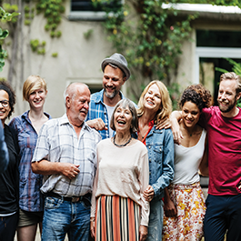 Group of people laughing and taking a picture together.