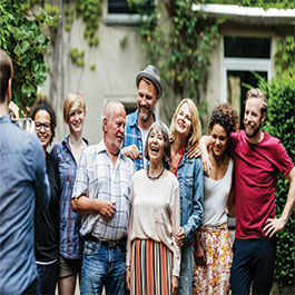 Group of people laughing and taking a picture together.